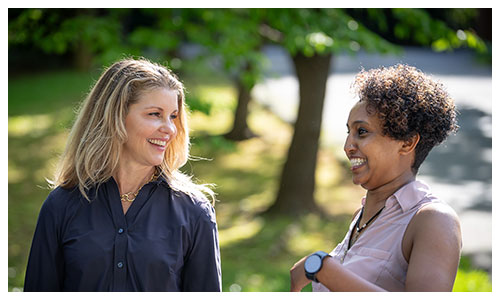 Jennifer talking with a resident and laughing